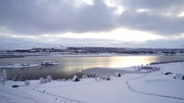 Snow-covered landscape with a serene lake