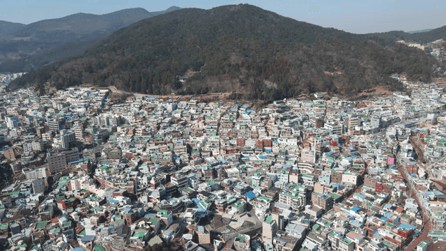 Colorful hillside village with mountains