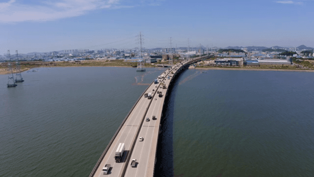 Bridge and cars over the blue river