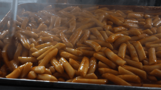 Tteokbokki simmering in a large pan