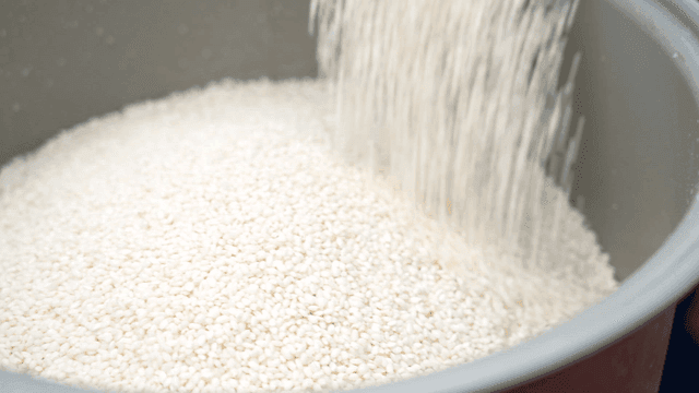 Rice being poured into a pot