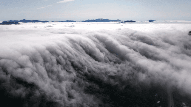 Clouds cascading over a mountain range