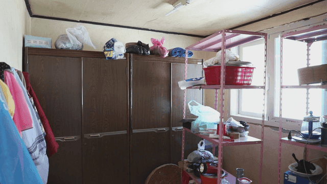 Cluttered room with shelves and cabinets