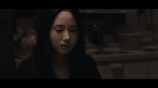 Woman talking in a dark room
