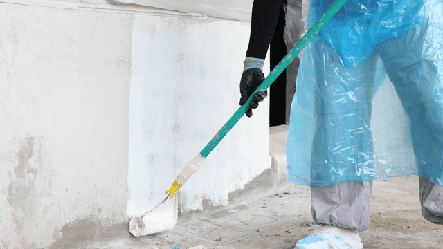 Person painting wall with roller