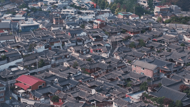 Panoramic view of a Hanok village lined with traditional tiled roofs