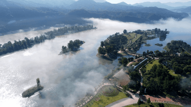 Quiet river landscape shrouded in fog.