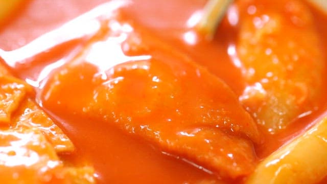 Spoonful of fish cake in spicy tteokbokki