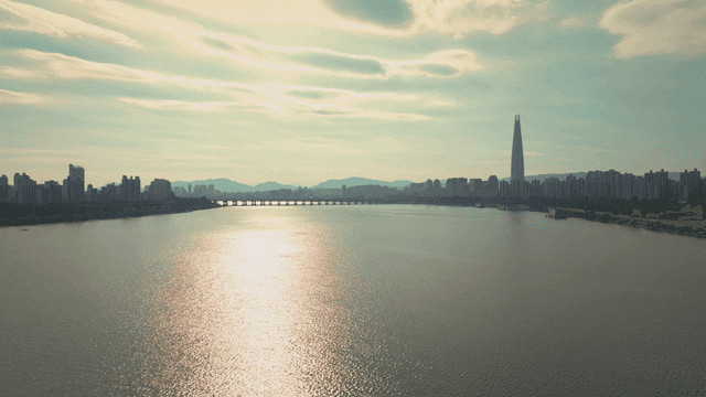 A river with a city skyline and bridge