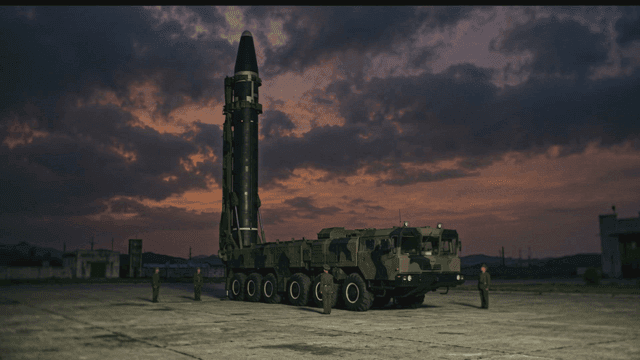 North Korean missile military launcher truck under night sky