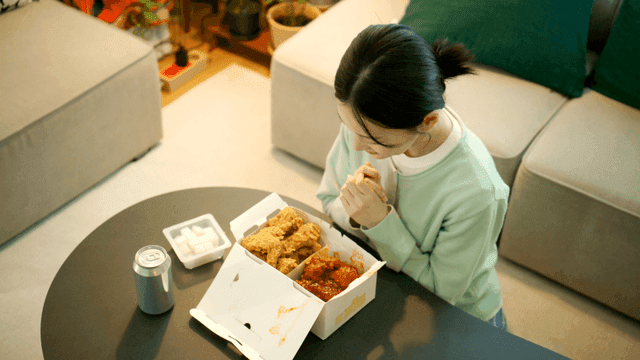 Woman preparing chicken for meal