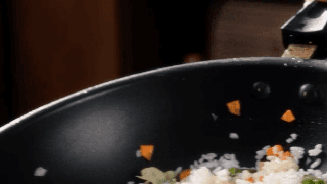 Vegetable fried rice being cooked in a pan