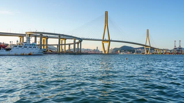 Busy Busanhangdaegyo Bridge and serene sea from day to night