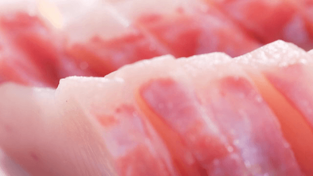 Fresh slices of raw fish on a plate