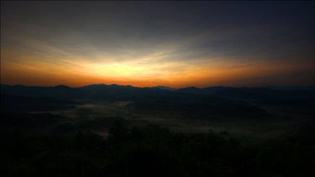 Sunrise over Misty Mountain Valley