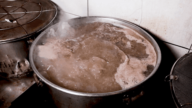 Meat broth boiling in large pot