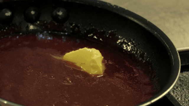Butter melting in a pan of red sauce