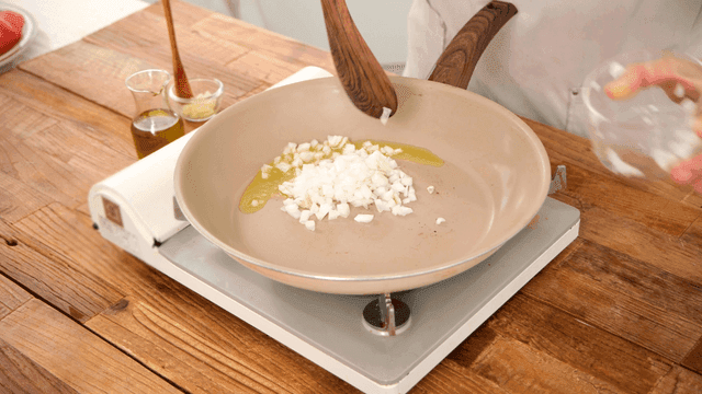 Chopped onions being added to a pan