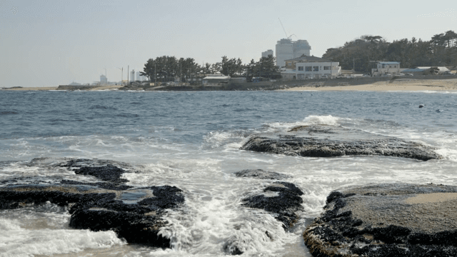 View of a coastal town with waves crashing