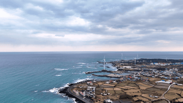 Coastal rural village with wind turbines