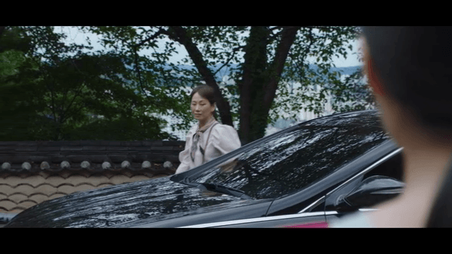 Woman getting out of a car and approaching