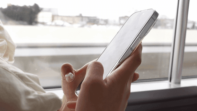 Person using a smartphone on a train