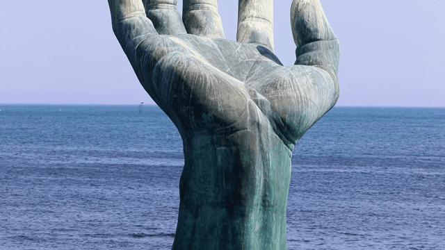 Large hand sculpture in the sea