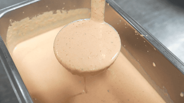 Ladle for scooping rose sauce from metal tray