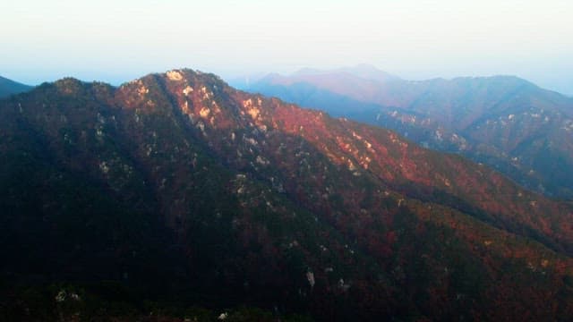 Sunlight shining on the autumn mountain covered in colorful autumn leaves