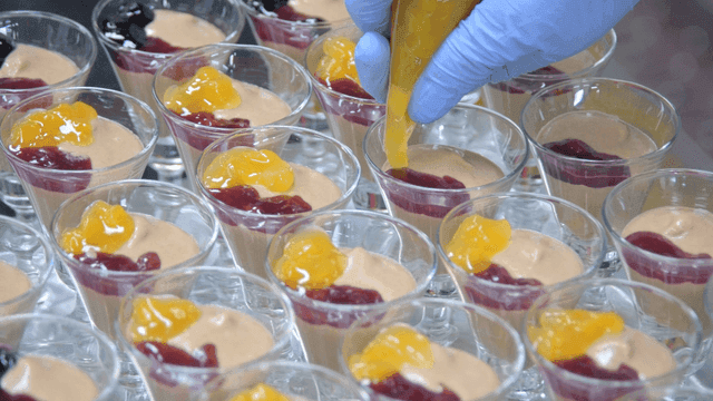 Dessert made with fruit jam using gloved hands