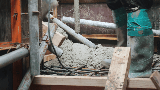 Workers pouring concrete at a construction site