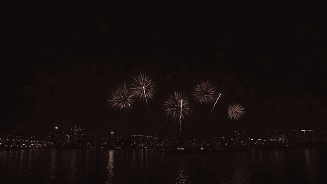 Fireworks over a city skyline at night