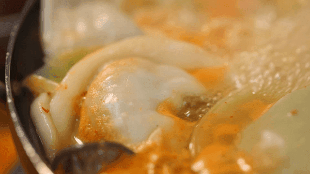 Dumpling hot pot boiling in spicy broth