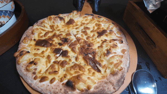 Cheese pizza on a wooden board