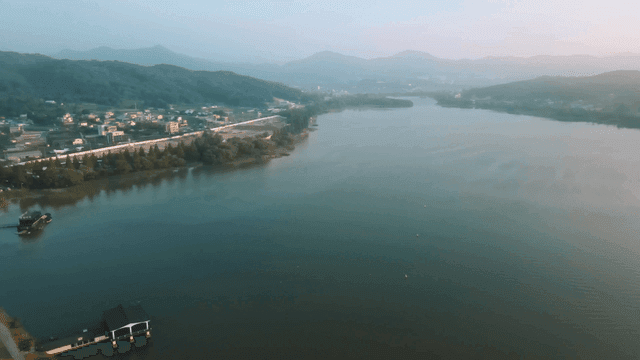Tranquil lake surrounded by hills and villages