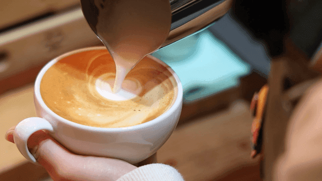 Latte art being created in a coffee cup