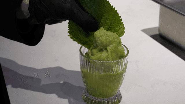Green dessert and perilla leaves in glass