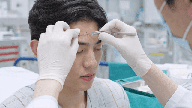 Doctor treating forehead wound
