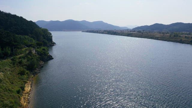 Scenic riverside view with distant green mountains