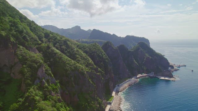 Lush mountains with clear sea