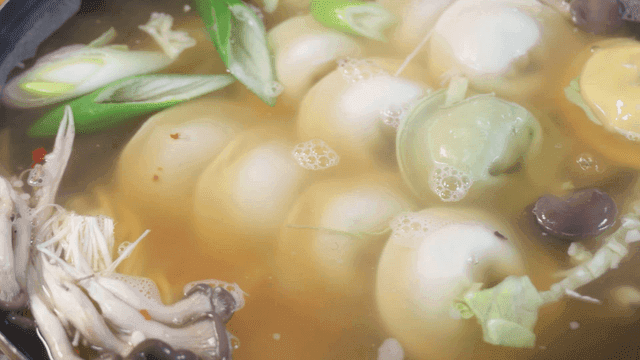 Dumpling hot pot boiling with mushrooms