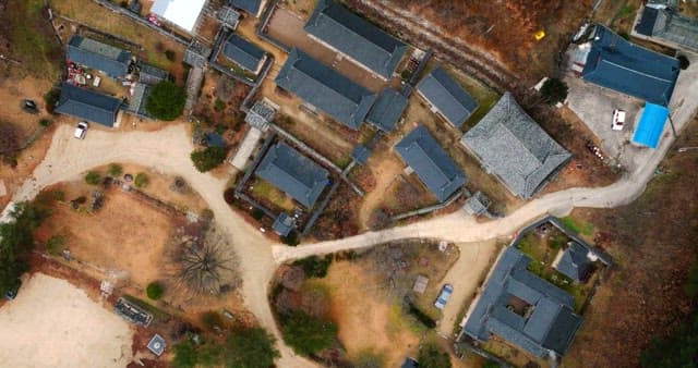 Aerial View of Traditional Village Surrounded by Forest