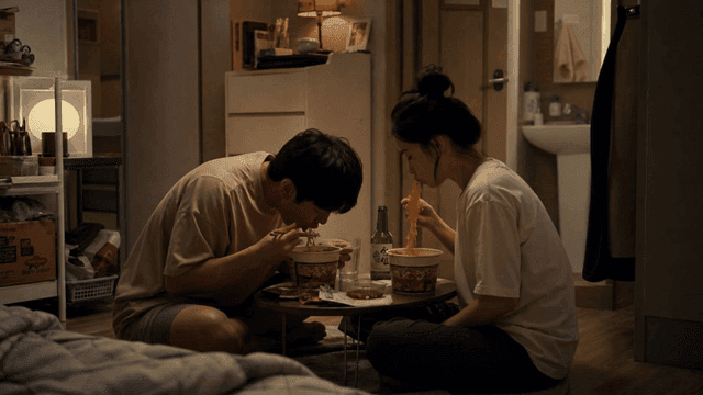 Couple eating cup noodles at home