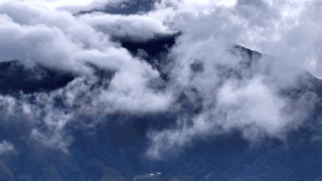 Clouds enveloping a mountain peak