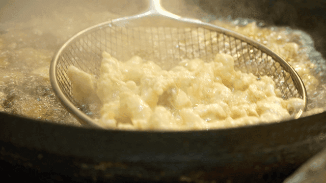 Sweet and sour pork fried in hot oil and taken out