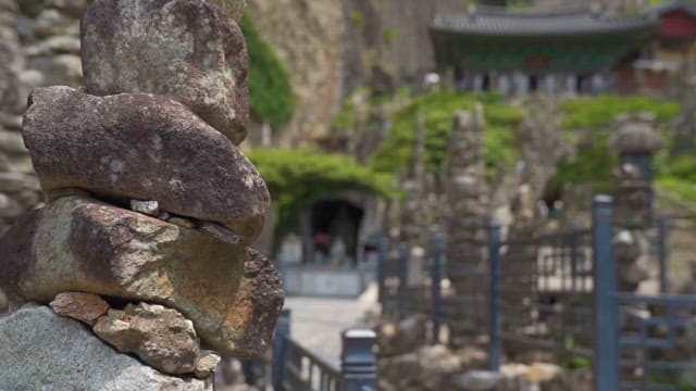 Stone stacked trail leading to a traditional temple