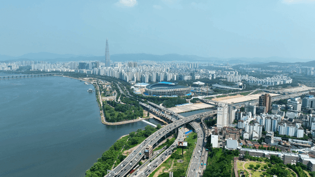 Vast city landscape with river and stadium