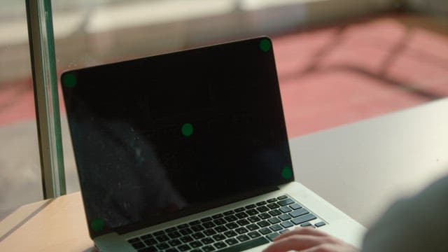 Person working on a laptop in natural light