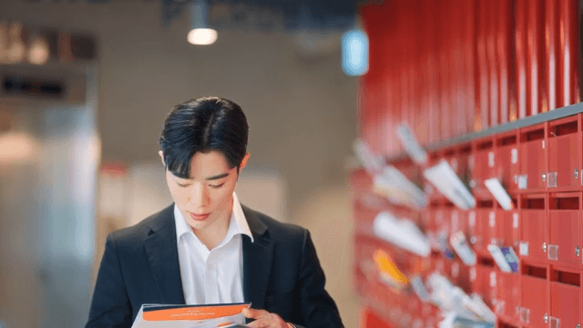 Man checking mail at red mailbox