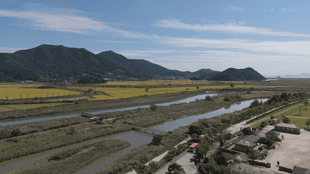 Expansive farmland with mountains in the background